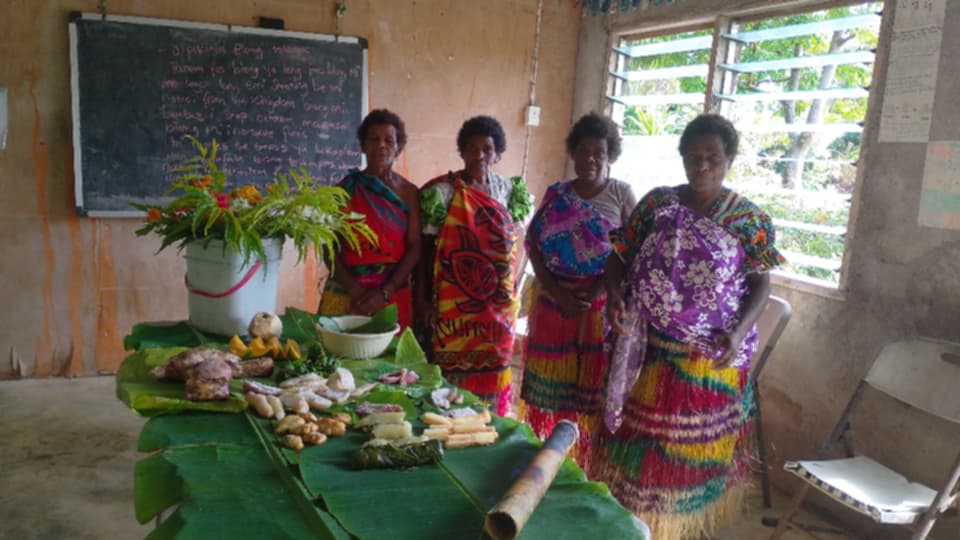 Local women presenting island-grown ingredients